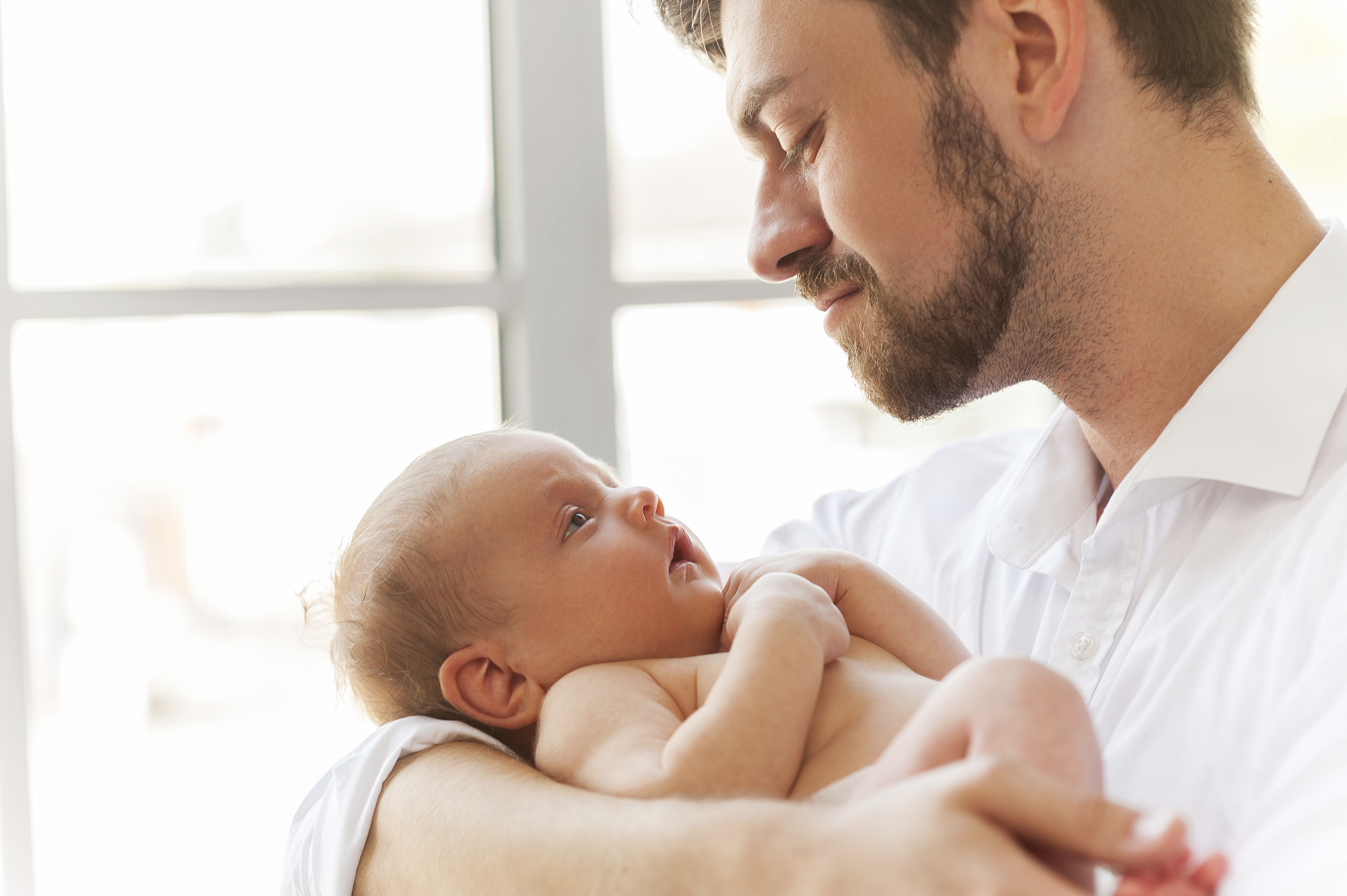 Father with little baby. Close-up of father holding cute little baby in hands Father and Baby